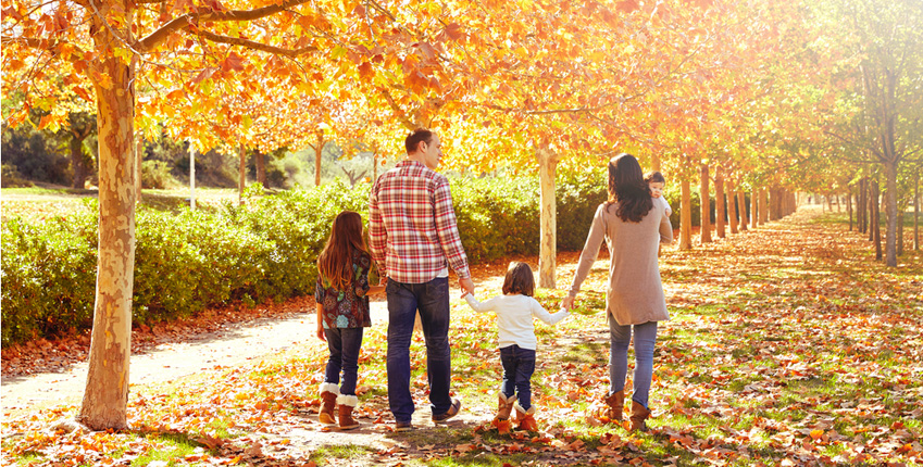 Family Walking in Fall Leaves
